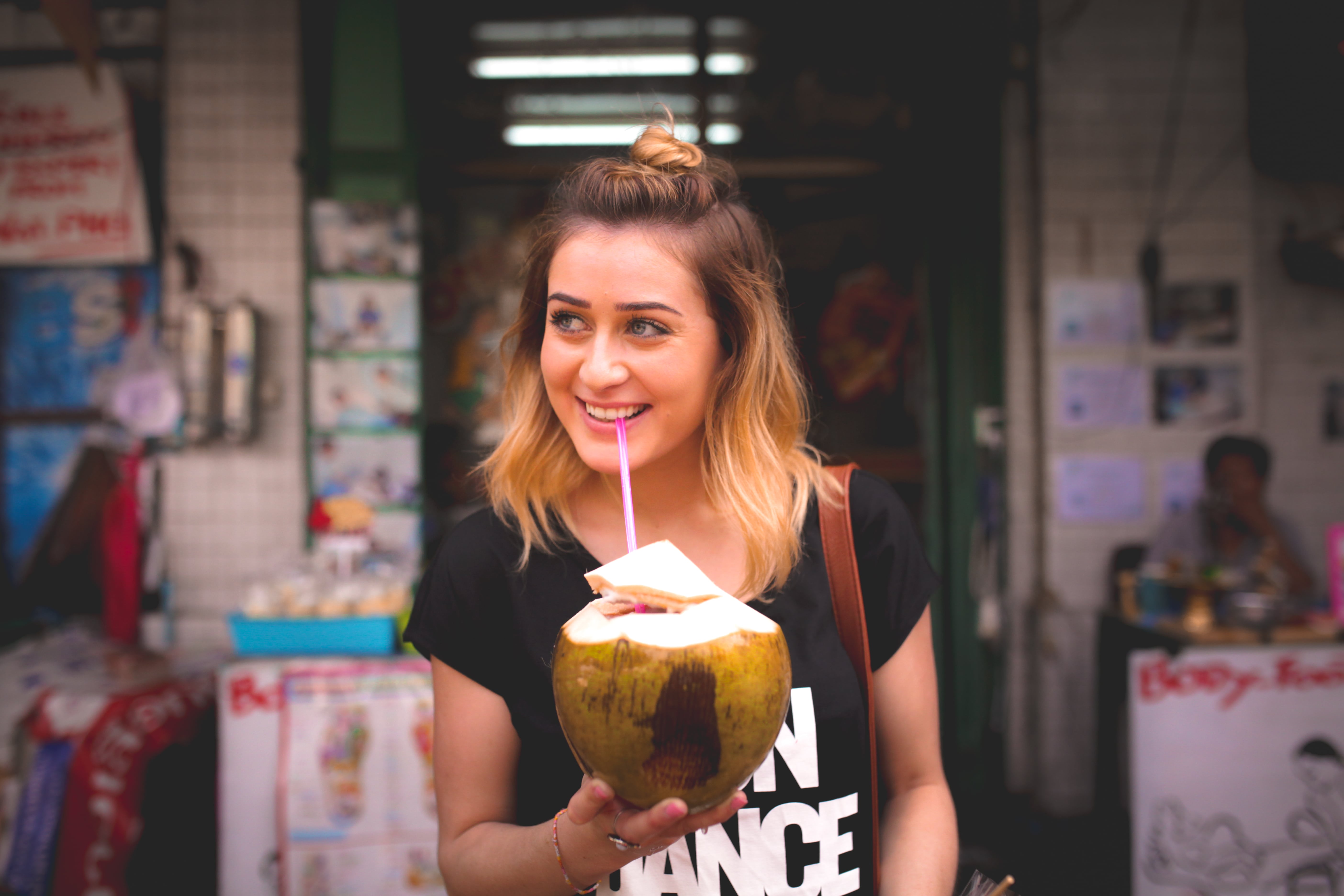 Ebony Day drink from a coconut